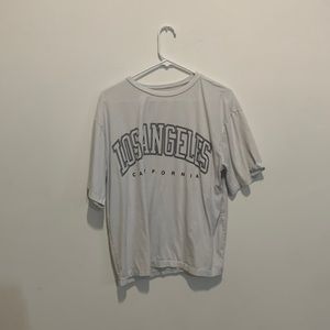This is a white oversized tee that has been cropped on the past!